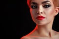 Beautiful young blonde red lipped woman posing in artistic red l Royalty Free Stock Photo