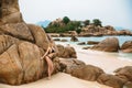 Beautiful young blonde woman in black bikini posing on the beach. model portrait with perfect body. Concept of Royalty Free Stock Photo