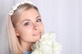 Beautiful young blonde woman with clean skin and flower Royalty Free Stock Photo