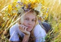 Beautiful young blonde woman with flower wreath on head Royalty Free Stock Photo