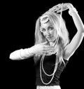 Beautiful young blonde woman oriental dance on dark background. Royalty Free Stock Photo