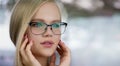 Beautiful young blonde woman with perfect skin, natural long light blond hair and glasses Royalty Free Stock Photo