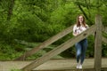 Beautiful young blonde woman poses in woods - spring fashion Royalty Free Stock Photo