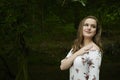 Beautiful young blonde woman poses in woods - spring fashion Royalty Free Stock Photo