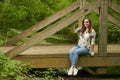 Beautiful young blonde woman poses in woods - spring fashion Royalty Free Stock Photo