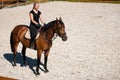 Beautiful young blonde woman riding a horse