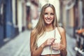 Beautiful young blonde woman smiling in urban background. Royalty Free Stock Photo