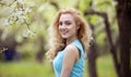 Beautiful young blonde woman in spring portrait of young lovely woman in spring flowers Royalty Free Stock Photo