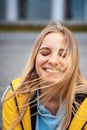 Beautiful young blonde woman on the street, posing with wind in her hair Royalty Free Stock Photo