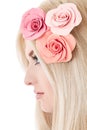 Beautiful young blonde woman with tender flowers in her hair Royalty Free Stock Photo