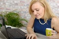 Beautiful young blonde woman using laptop Royalty Free Stock Photo