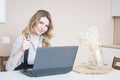 Beautiful young blonde woman using laptop Royalty Free Stock Photo