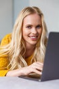 beautiful young blonde woman using laptop and smiling Royalty Free Stock Photo