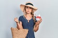 Beautiful young blonde woman wearing summer style eating ice cream puffing cheeks with funny face Royalty Free Stock Photo
