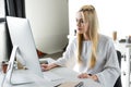 beautiful young blonde woman working with desktop computer Royalty Free Stock Photo
