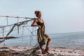 Beautiful young boho style woman posing at the beach at sunset Royalty Free Stock Photo