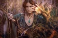 Beautiful young boho woman portrait outdoors at sunset