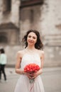 Beautiful young bride with bridal bouquet on the background church