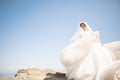 Beautiful young bride with bridal bouquet posing on the background sea Royalty Free Stock Photo