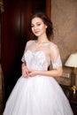 Beautiful young Bride with brunette hairs in a bedroom. Classic white wedding dress. Close up portrait Royalty Free Stock Photo