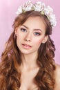 Beautiful young bride with a floral ornament in her hair.Beautiful Woman Touching her Face. Youth and Skin Care Concept.Nymph. Royalty Free Stock Photo