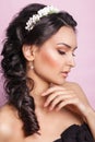 Beautiful young bride with a floral ornament in her hair.Beautiful Woman Touching her Face. Youth and Skin Care Concept.Nymph. Royalty Free Stock Photo