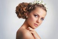 Beautiful young bride with a floral ornament in her hair.Beautiful Woman Touching her Face. Youth and Skin Care Concept on white Royalty Free Stock Photo