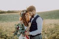 Beautiful bride and groom at sunset in green nature. Royalty Free Stock Photo