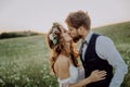 Beautiful bride and groom at sunset in green nature. Royalty Free Stock Photo