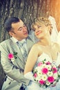 Beautiful young bride and groom looking and smiling standing on Royalty Free Stock Photo