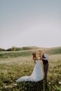 Beautiful bride and groom at sunset in green nature. Royalty Free Stock Photo