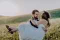 Beautiful bride and groom at sunset in green nature. Royalty Free Stock Photo