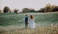 Beautiful bride and groom at sunset in green nature. Royalty Free Stock Photo