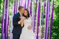 Beautiful young bride and groom at a wedding ceremony when in the background of multi-colored ribbons, marriage, relationships, c