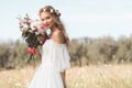 beautiful young bride holding wedding bouquet and smiling at camera outdoors Royalty Free Stock Photo