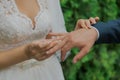 A beautiful young bride puts a wedding ring on her finger to the groom on her wedding day, they are happy Royalty Free Stock Photo