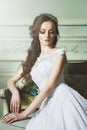 Beautiful Young Bride Sensualy Posing On Sofa. White Wedding Dress Royalty Free Stock Photo