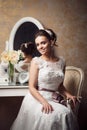 Beautiful young bride sitting near mirror Royalty Free Stock Photo