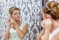 Beautiful young bride sitting near mirror Royalty Free Stock Photo