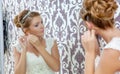 Beautiful young bride sitting near mirror Royalty Free Stock Photo