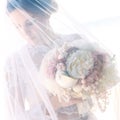 Beautiful young bride in the veil, with wedding bouquet of white Royalty Free Stock Photo