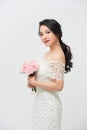 Beautiful young bride in wedding dress holding bouquet over white background. Copy space Royalty Free Stock Photo