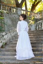 Beautiful young bride in wedding dress on the steps. Royalty Free Stock Photo