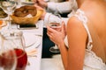 Beautiful young bride in white dress playfully raised a glass of champagne at wedding, and want to make a toast, clink glasses
