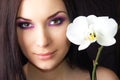 Beautiful young brunet woman with orchid flower Royalty Free Stock Photo