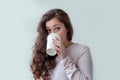 Beautiful young brunete woman with take away paper coffee cup  on white background. Happy smiling girl having lunch break Royalty Free Stock Photo