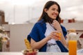 Beautiful young brunette caucasian woman is drinking orange cocktail in summer on terrace. Royalty Free Stock Photo