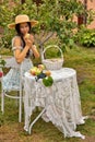 Beautiful young caucasian woman sitting in an orchard