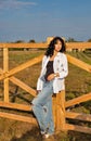 Beautiful young caucasian woman standing at the ranch gate Royalty Free Stock Photo