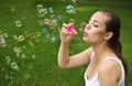 Beautiful young brunette girl blowing soap bubbles Royalty Free Stock Photo